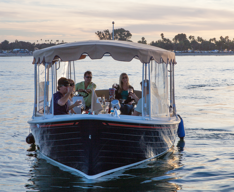 Group enjoying drinks on a Duffy boat